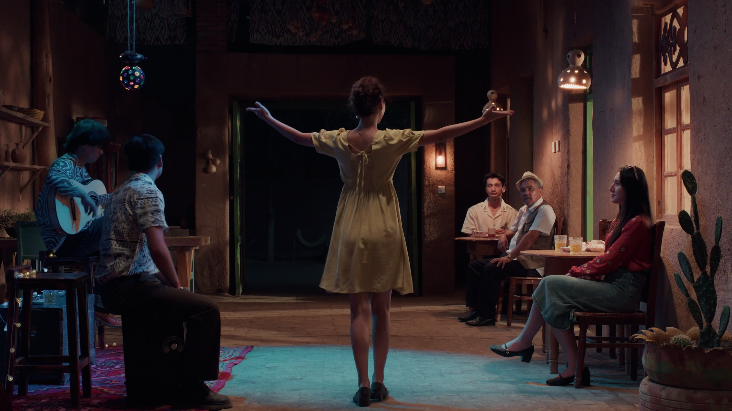 A performer standing in a tavern room