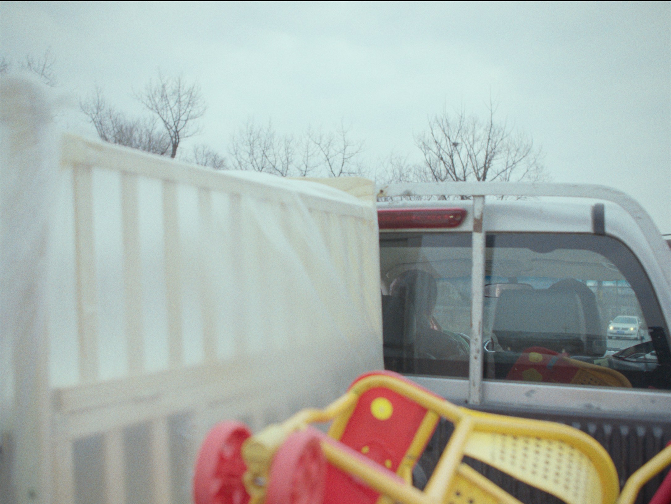 A red chair in the back of a truck