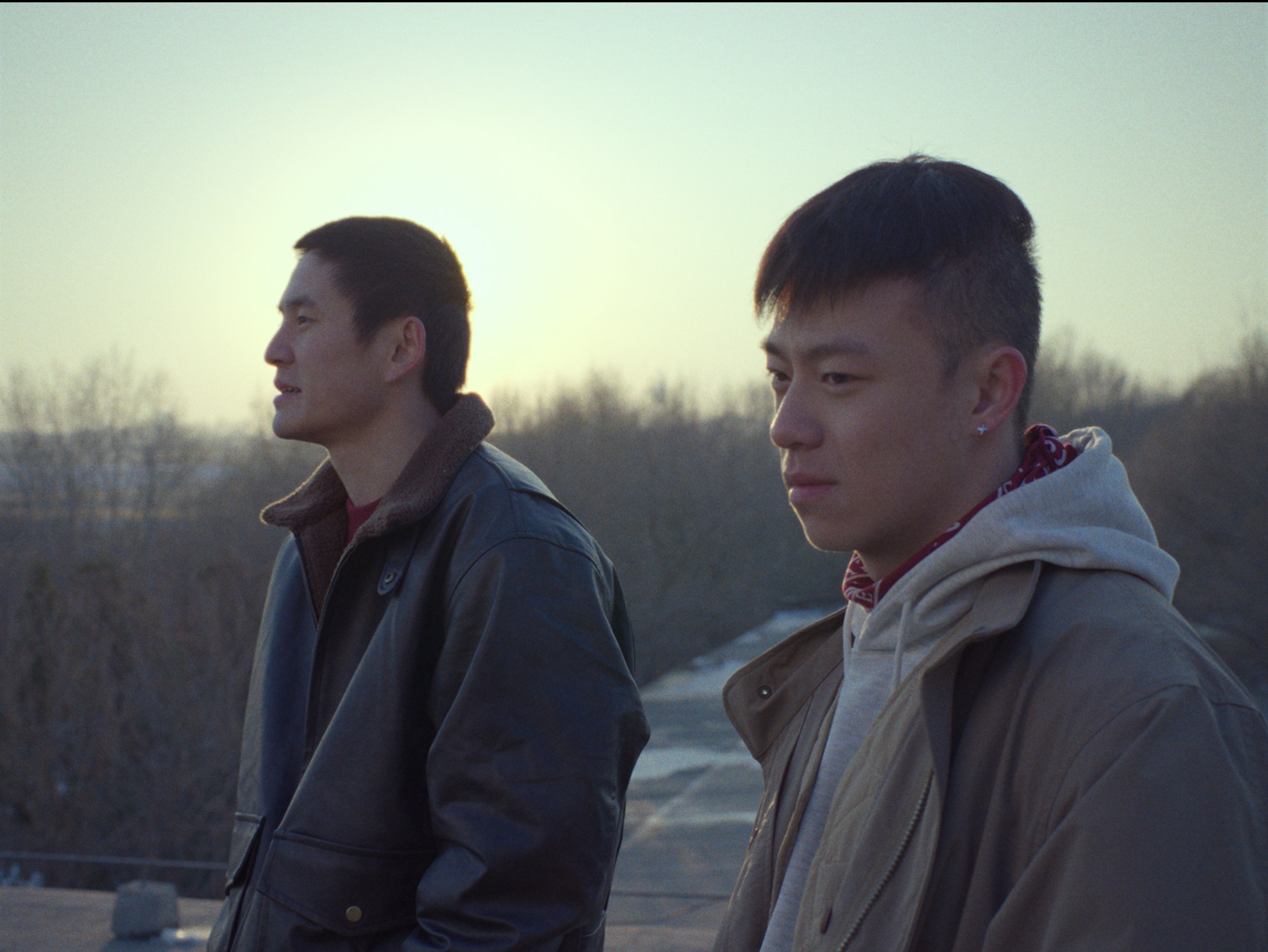 Two men sitting in winter light