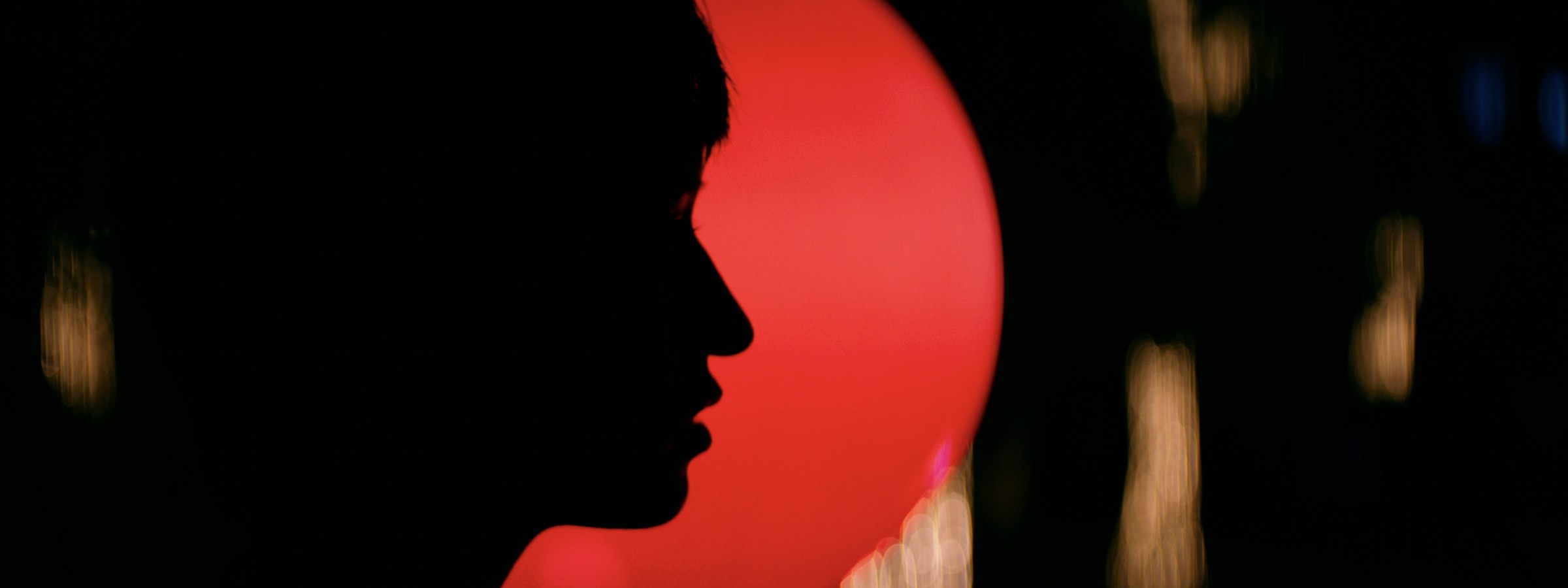 A red profile silhouette