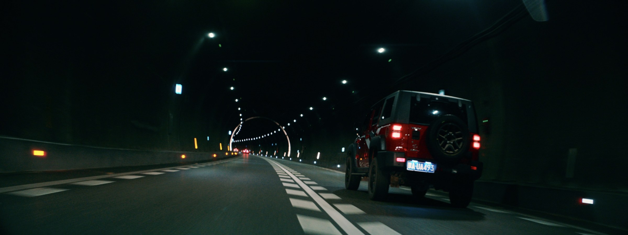 A road at night seen from a moving car